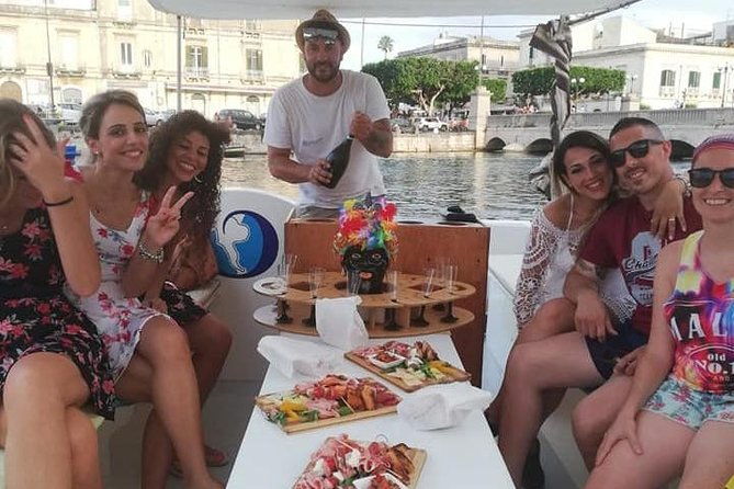 aperitif-on-the-boat-at-sunset-island-and-sea-caves