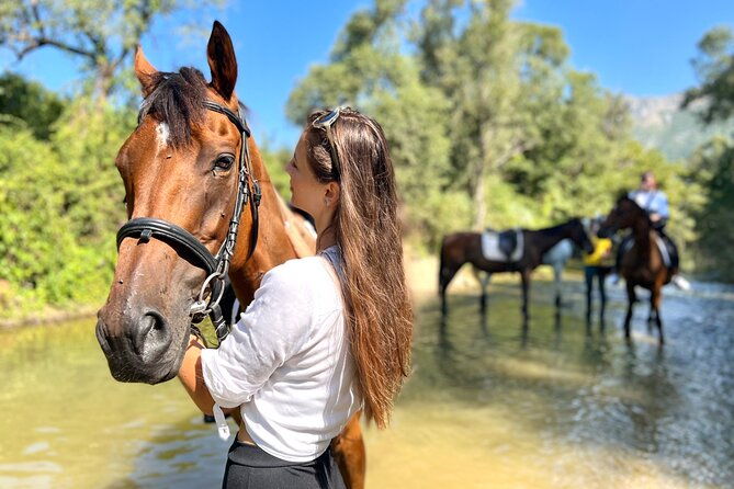 horseback-riding-across-river-ljuta-with-transport