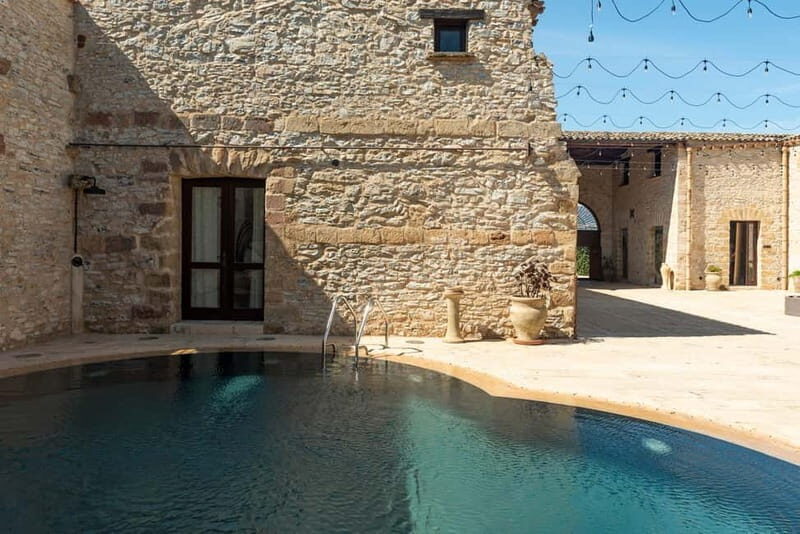 Nature and relaxation by the pool at Baglio Passofondo Estates - A Closer Look at the Experience
