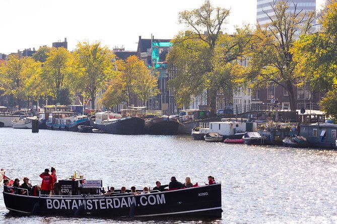open-boat-canal-cruise-in-old-city-centre-of-amsterdam