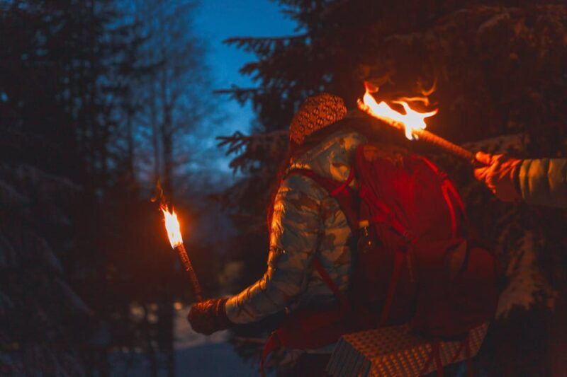 oslo-snowy-forest-torchlight-walk-with-campfire