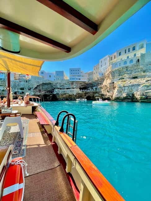 Polignano Monopoli: boat tour on a traditional wooden boat at sunset - Key Points